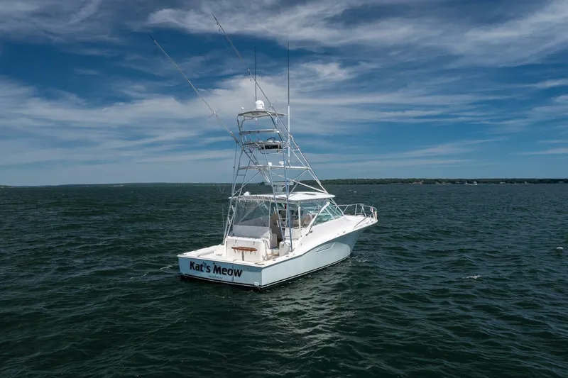 Kat's Meow Yacht Photos Pics 2004 Cabo 40 Express boat on open water under a clear blue sky.