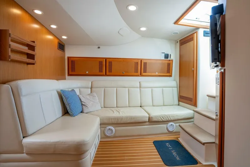 Kat's Meow Yacht Photos Pics Luxurious interior of 2004 Cabo 40 Express yacht with cream leather seating and wooden accents.