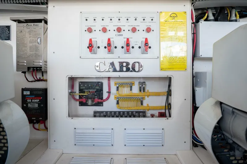 Kat's Meow Yacht Photos Pics Electrical panel of a 2004 Cabo 40 Express boat, featuring switches and wiring.