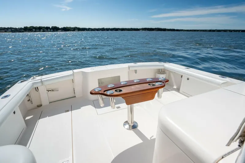 Kat's Meow Yacht Photos Pics 2004 Cabo 40 Express boat deck with ocean view and fishing rod holders.