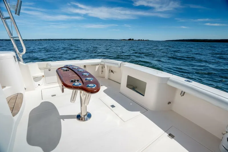 Kat's Meow Yacht Photos Pics 2004 Cabo 40 Express boat deck with ocean view and fishing rod holders.