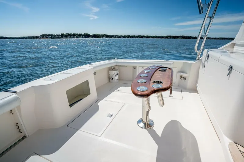 Kat's Meow Yacht Photos Pics 2004 Cabo 40 Express boat deck with ocean view and fishing rod holders.