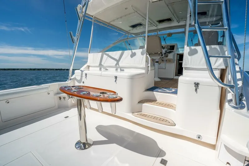 Kat's Meow Yacht Photos Pics 2004 Cabo 40 Express yacht interior with seating, table, and ocean view.