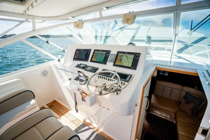 Kat's Meow Yacht Photos Pics 2004 Cabo 40 Express yacht helm with navigation screens and luxurious interior.