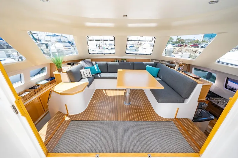 Making Waves Yacht Photos Pics Spacious interior of 2006 Seawind 1160 catamaran with modern seating and large windows.