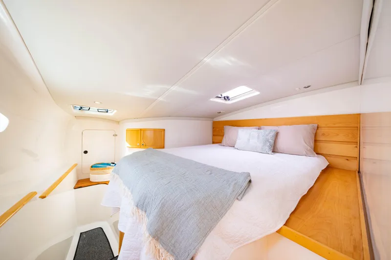 Making Waves Yacht Photos Pics Interior cabin of 2006 Seawind 1160 catamaran with cozy bed and natural light.