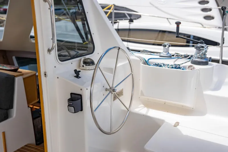 Making Waves Yacht Photos Pics Steering wheel of a 2006 Seawind 1160 catamaran, showcasing cockpit details and winches.
