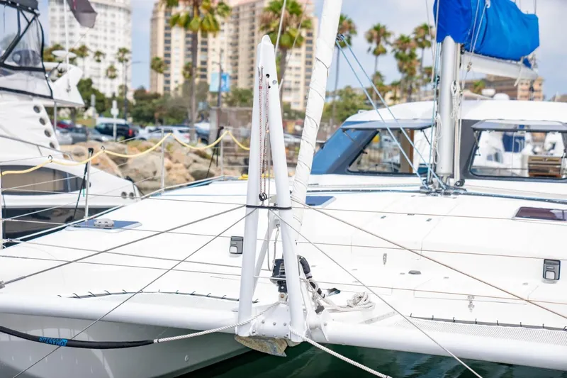 Making Waves Yacht Photos Pics 2006 Seawind 1160 catamaran docked, with cityscape and palm trees in background.