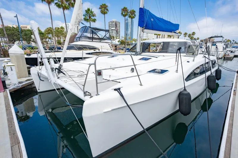 Making Waves Yacht Photos Pics 2006 Seawind 1160 catamaran docked at marina with blue sail cover.
