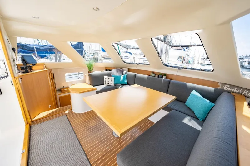 Making Waves Yacht Photos Pics Spacious interior of 2006 Seawind 1160 catamaran with modern seating and large windows.