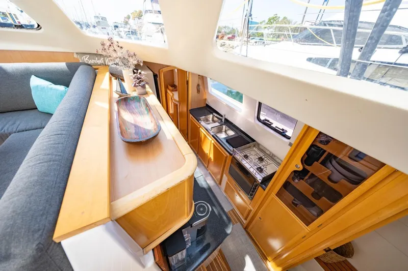Making Waves Yacht Photos Pics Interior of 2006 Seawind 1160 catamaran with modern kitchen and cozy seating area.