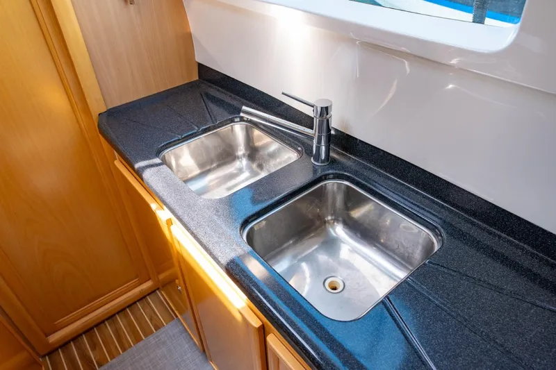 Making Waves Yacht Photos Pics Modern kitchen sink area on a 2006 Seawind 1160 catamaran, featuring dual stainless steel sinks.