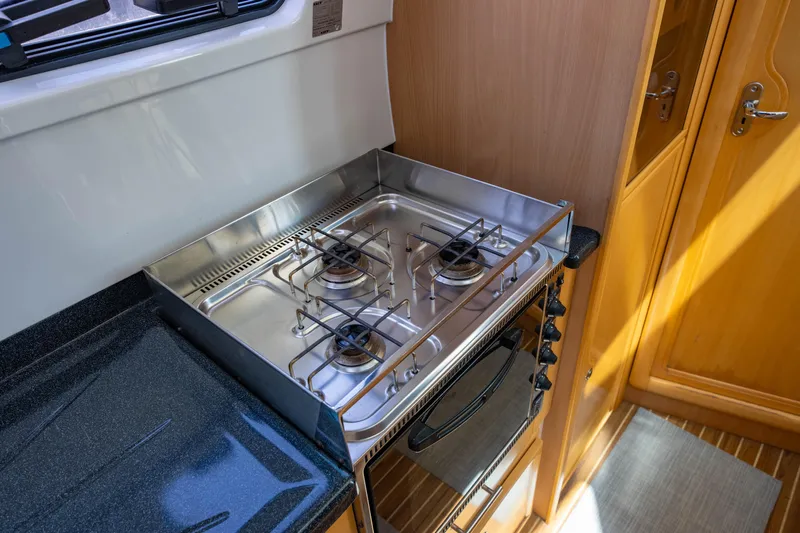 Making Waves Yacht Photos Pics Compact kitchen with stainless steel stove in a 2006 Seawind 1160 catamaran.