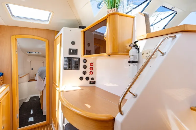 Making Waves Yacht Photos Pics Interior of 2006 Seawind 1160 catamaran, featuring wood accents and control panel.