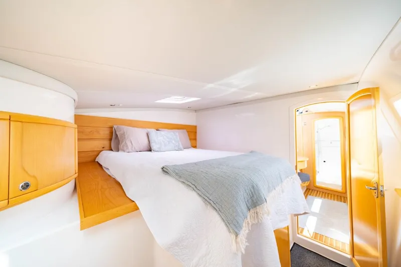 Making Waves Yacht Photos Pics Interior of 2006 Seawind 1160 catamaran with cozy bed and wooden accents.