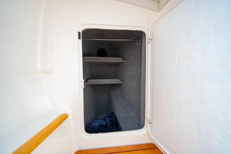 Making Waves Yacht Photos Pics Seawind 1160 (2006) interior storage compartment with shelves and wooden accents.