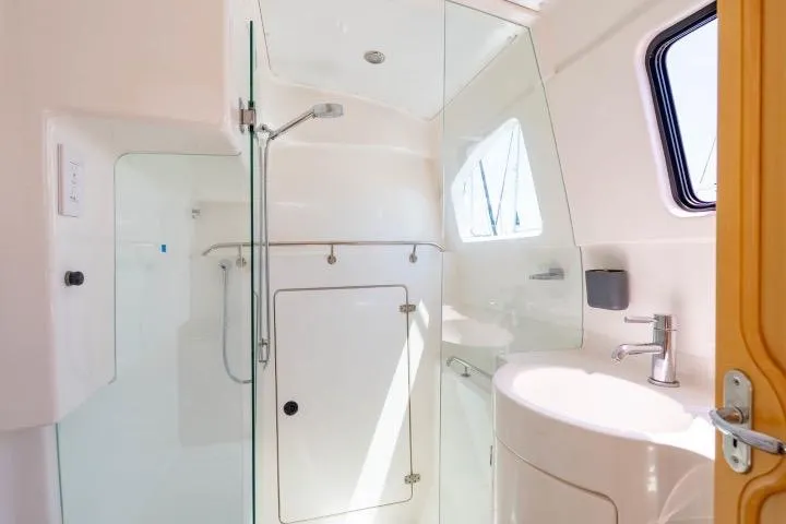 Making Waves Yacht Photos Pics Bathroom interior of 2006 Seawind 1160 yacht with modern fixtures and glass shower.