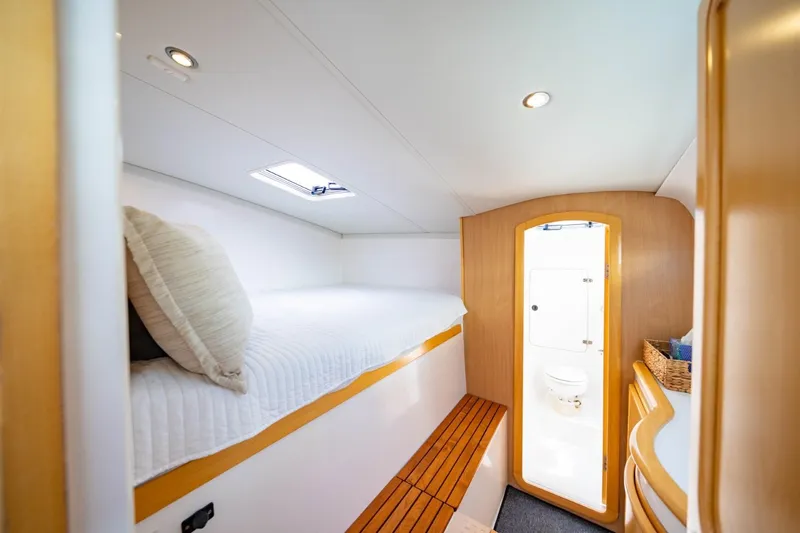 Making Waves Yacht Photos Pics Interior cabin of 2006 Seawind 1160 catamaran with bed and bathroom.