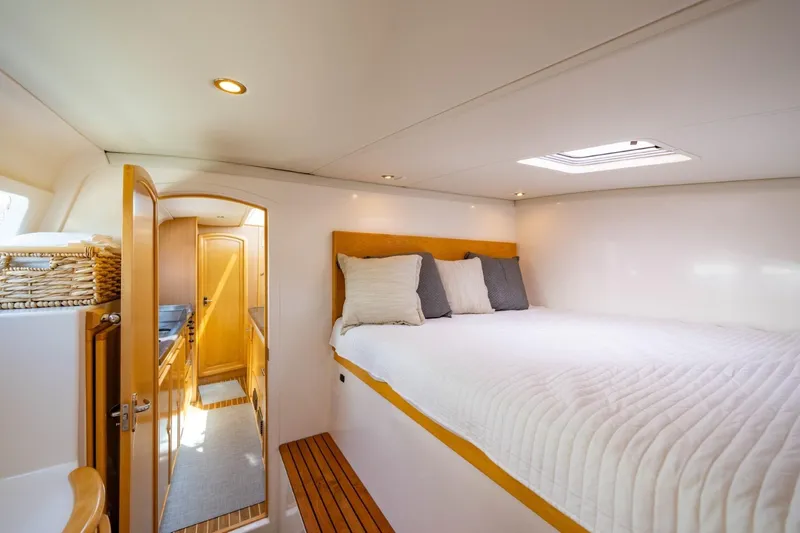 Making Waves Yacht Photos Pics Luxurious cabin interior of 2006 Seawind 1160 catamaran with cozy bed and natural lighting.