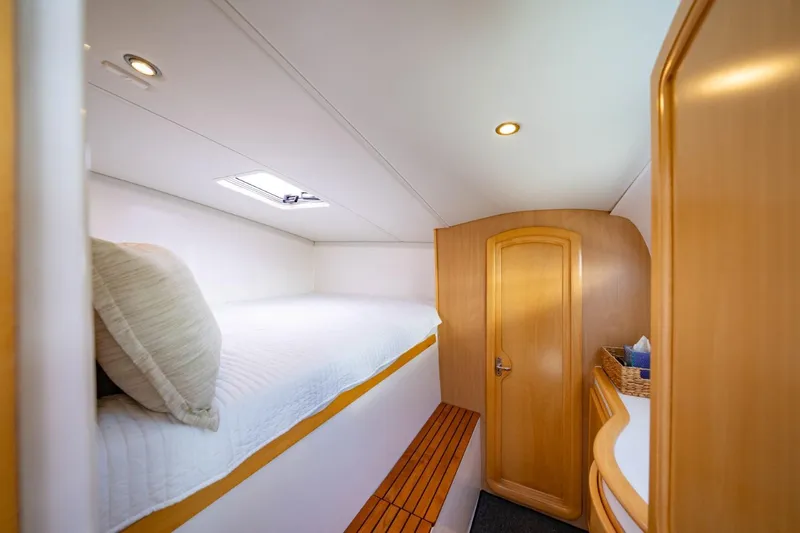 Making Waves Yacht Photos Pics Cozy cabin interior of 2006 Seawind 1160 catamaran with wooden accents and skylight.