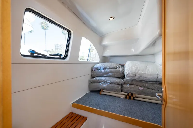 Making Waves Yacht Photos Pics Interior cabin of 2006 Seawind 1160 catamaran with window and stacked bedding.