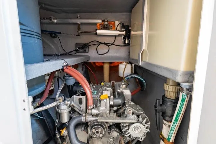 Making Waves Yacht Photos Pics Engine compartment of a 2006 Seawind 1160 catamaran, showcasing mechanical components and hoses.