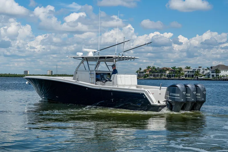  Yacht Photos Pics 2015 Invincible 42 Open Fisherman boat cruising on a sunny day with Yamaha engines.