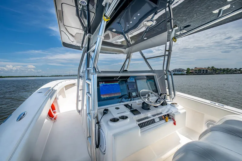  Yacht Photos Pics 2015 Invincible 42 Open Fisherman boat cockpit with navigation equipment on a sunny day.