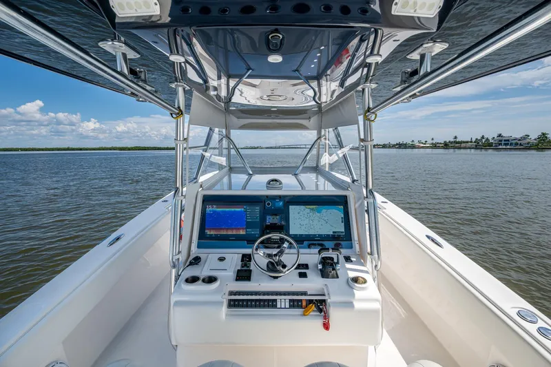  Yacht Photos Pics 2015 Invincible 42 Open Fisherman boat dashboard with navigation screens on open water.