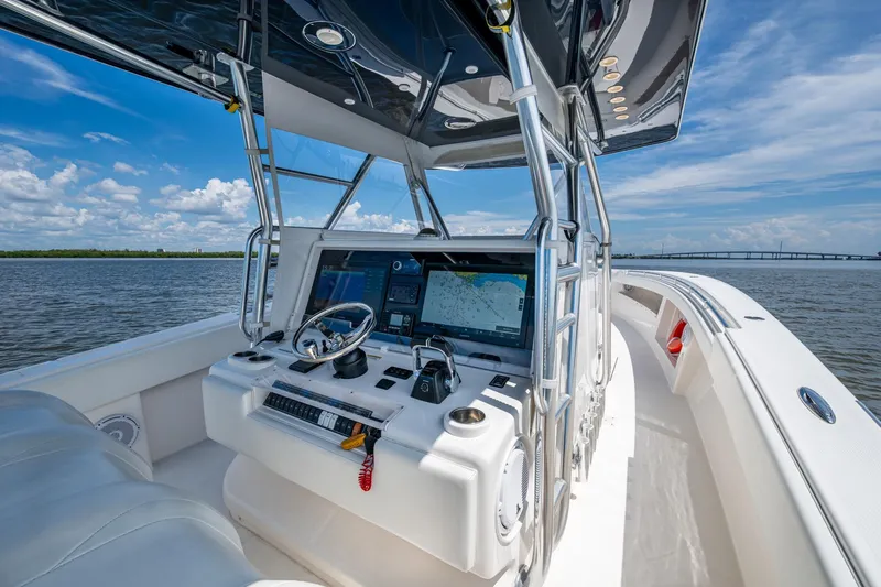  Yacht Photos Pics 2015 Invincible 42 Open Fisherman boat dashboard with navigation screens on open water.