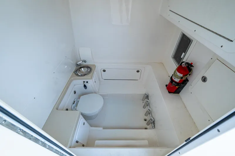  Yacht Photos Pics 2015 Invincible 42 Open Fisherman boat interior with toilet, sink, and fire extinguisher.
