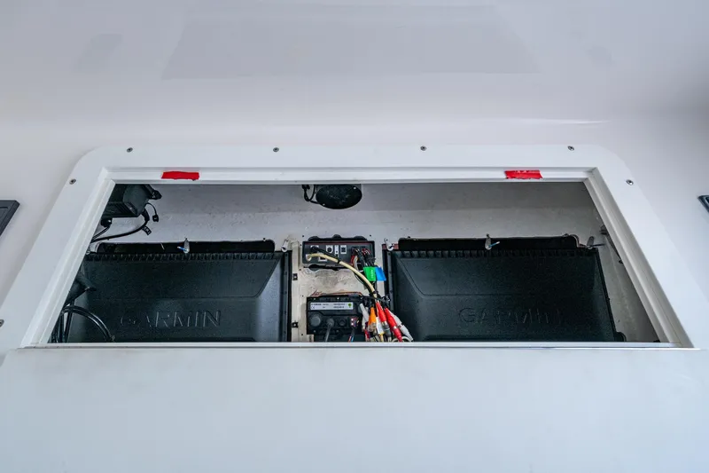  Yacht Photos Pics 2015 Invincible 42 Open Fisherman electronics compartment with Garmin equipment and wiring.