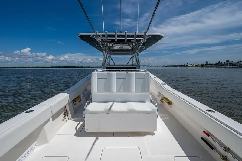  Yacht Photos Pics 2015 Invincible 42 Open Fisherman boat on calm water under a clear blue sky.