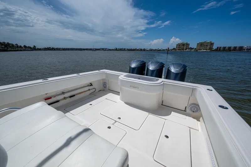  Yacht Photos Pics 2015 Invincible 42 Open Fisherman boat with triple engines on calm water.