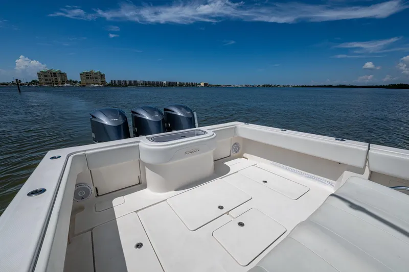  Yacht Photos Pics 2015 Invincible 42 Open Fisherman boat with triple engines on calm water.