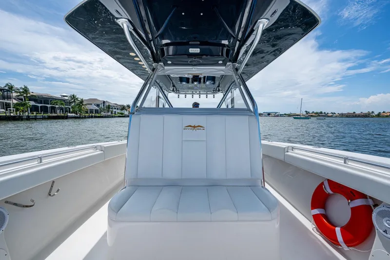  Yacht Photos Pics 2015 Invincible 42 Open Fisherman boat interior with seating and life preserver on a sunny day.