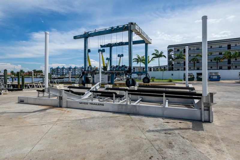  Yacht Photos Pics Boat lift and trailer at marina, clear sky, Invincible 42 Open Fisherman, 2015 model.