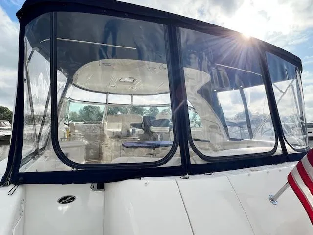  Yacht Photos Pics 2005 Sea Ray 500 Sundancer yacht with enclosed cockpit, American flag, and sunlit sky.