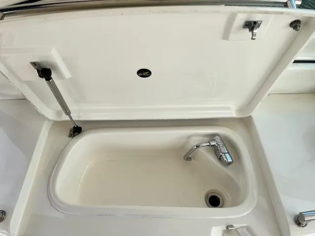  Yacht Photos Pics Open storage compartment with faucet on 2005 Sea Ray 500 Sundancer yacht.