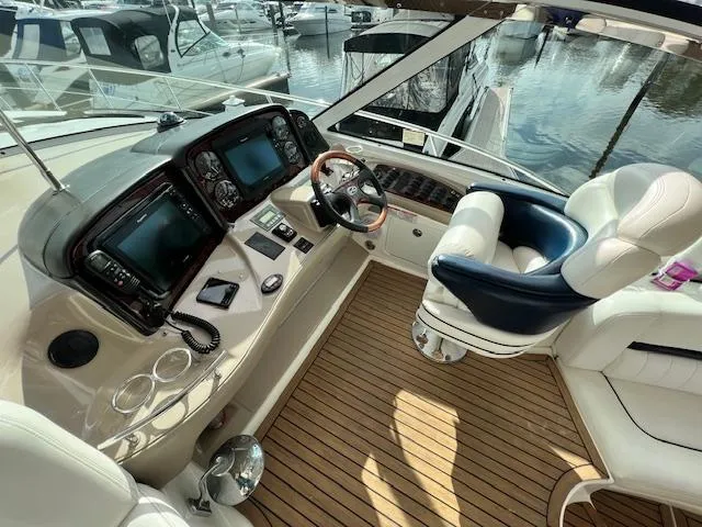  Yacht Photos Pics Helm of 2005 Sea Ray 500 Sundancer with modern controls and luxurious seating.