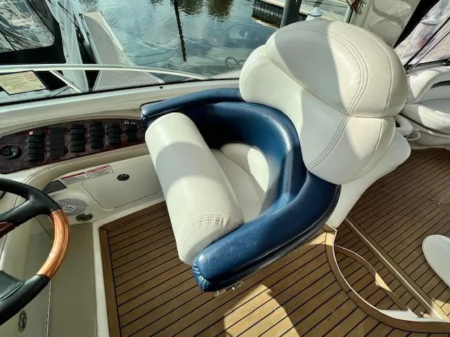  Yacht Photos Pics Captain's chair on 2005 Sea Ray 500 Sundancer yacht, featuring luxurious white and blue upholstery.