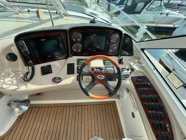  Yacht Photos Pics Helm of 2005 Sea Ray 500 Sundancer with wood accents and modern navigation equipment.