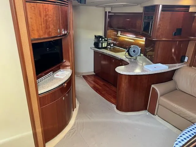  Yacht Photos Pics Luxurious interior of 2005 Sea Ray 500 Sundancer yacht with modern kitchen and seating area.