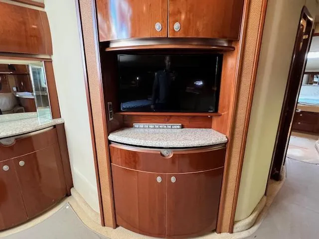  Yacht Photos Pics Luxurious interior of 2005 Sea Ray 500 Sundancer with TV and wooden cabinetry.