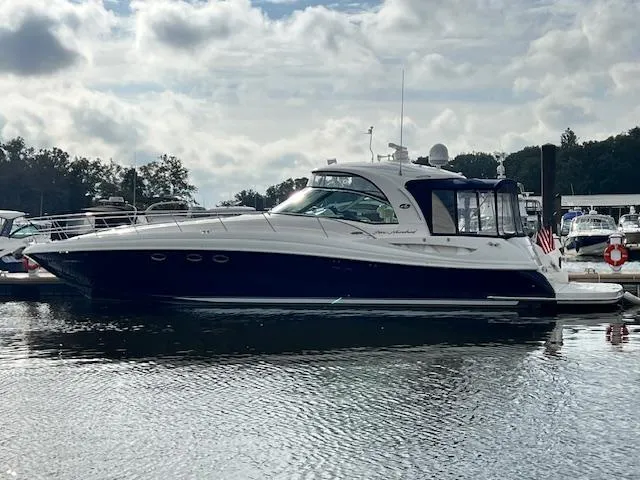  Yacht Photos Pics 2005 Sea Ray 500 Sundancer yacht docked on a calm, reflective water surface.
