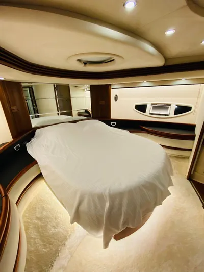  Yacht Photos Pics Luxurious bedroom interior of a 2006 Azimut 68 yacht with elegant lighting.