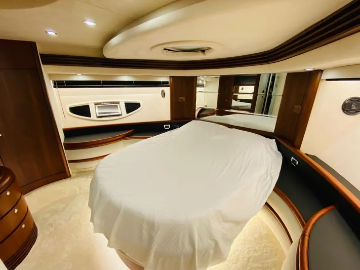  Yacht Photos Pics Luxurious bedroom interior of a 2006 Azimut 68 yacht with elegant wood finishes.