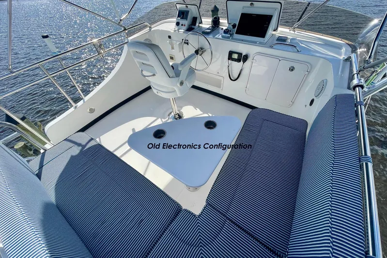 Slainte II Yacht Photos Pics 2008 Nordic Tug 42 boat helm with old electronics configuration and striped seating.