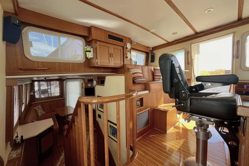 Slainte II Yacht Photos Pics Interior of 2008 Nordic Tug 42, featuring wood finishes and a captain's chair.