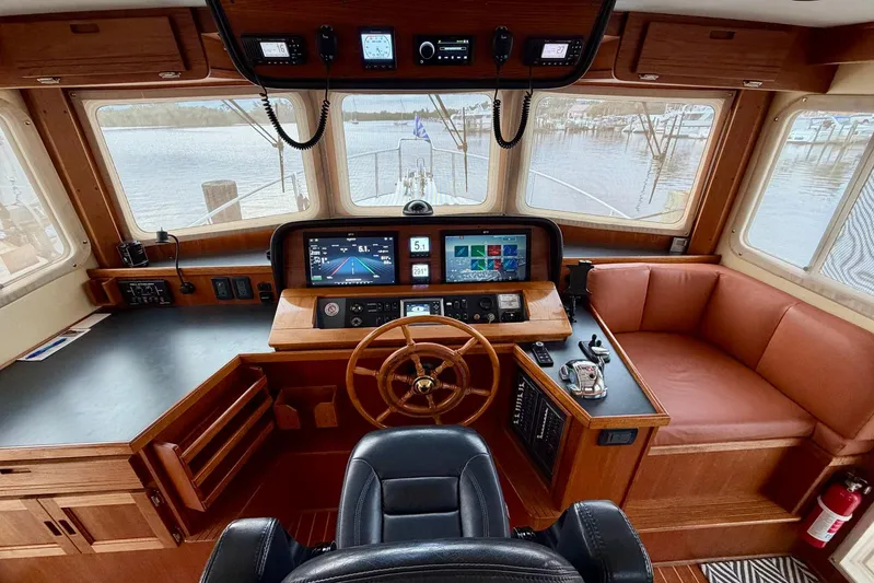Slainte II Yacht Photos Pics Pilothouse of 2008 Nordic Tug 42 with navigation equipment and leather seating.